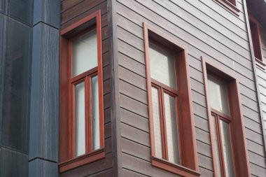 Çağdaş bir binada eşsiz pencere tasarımlarının ayrıntılı görünümü.