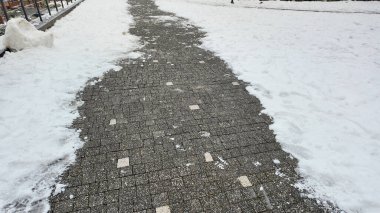 Karlı bir patika kışın sakin bir şehir bölgesinde esiyor..