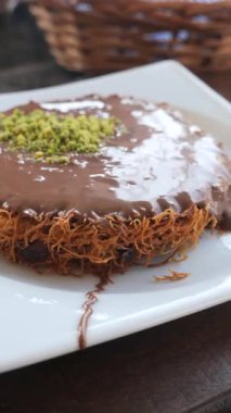 Tabağında çikolata olan lezzetli kunafa. .