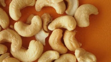 Fıstıklar turuncu bir zemine yayılmış, dokularını sergiliyorlar..