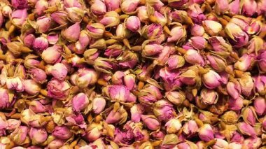 Kurumuş pembe gül tomurcukları sergilenir, canlı renkleri ve dokuları sergilenir.