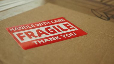 Kırılgan etiketli paketin yakın plan görüntüsü, teslimatta özen gösterilmesi.