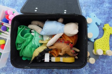 Renkli oyuncaklar ve el sanatları malzemeleri bir konteynırda güzelce depolanır..