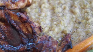 Izgara tavuğun yanında kremalı pirinç lezzetli bir pişirme işlemi ortaya çıkarır..