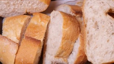 Slices of warm, crusty bread are arranged in a rustic bakery.