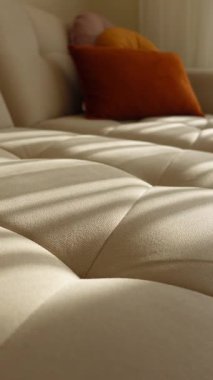 Soft shadows and warm colors create a peaceful atmosphere in a living room.