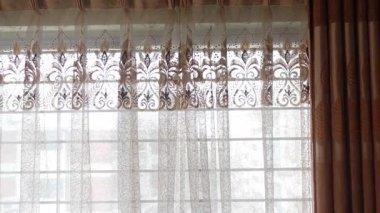 Sunlight shines through lace curtains in a warm, inviting space.