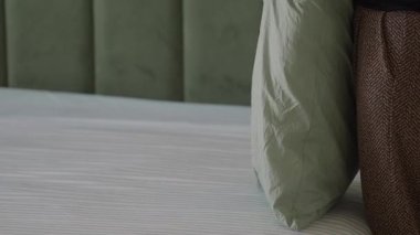 Learn how to efficiently fold and arrange pillows on your bed.