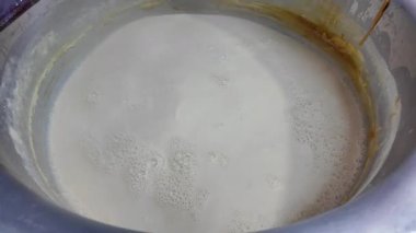Close-up of milk in a large container,