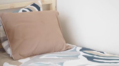 Soft pillows and unique bedding create a peaceful bedroom atmosphere.