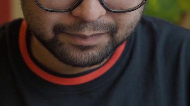 Close-up of a man eating salad .
