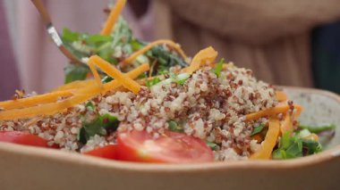 Learn how to make a nutritious quinoa salad with colorful veggies.