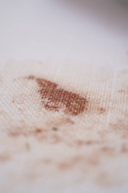 A brown stain remains on fabric after a coffee spill in the kitchen.
