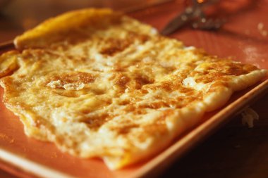 Delicious omelette egg served on a warm plate.