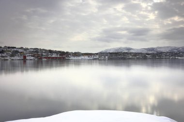 A view across Alta fjord towards the Alta waterfront in Northern Norway. clipart