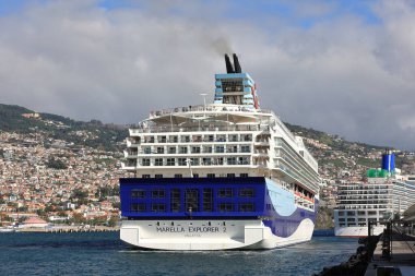 A view of Marella cruise ship, Marella Explorer 2 departs Funchal, Madeira.  The ship was launched in 1995. clipart