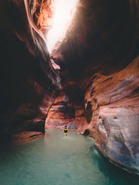 Tourist in Wadi Mujib gorge in Jordan which enters the Dead Sea at 410 meters below sea level. The Mujib Reserve of Wadi Mujib is the lowest nature reserve in the world clipart
