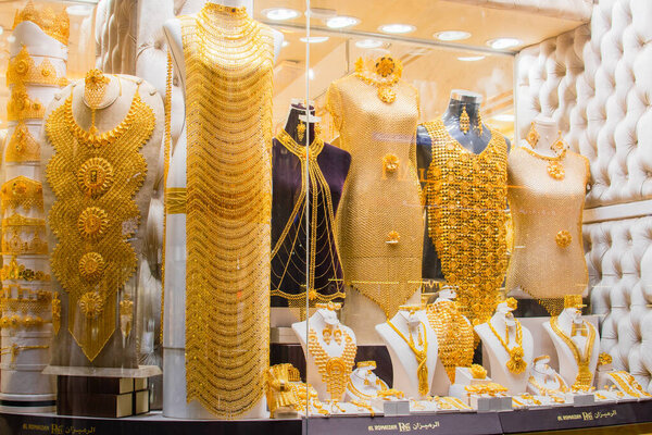Dubai, UAE - 12th october, 2022: most expensive shop items - luxury golden dresses and outfits for woman on shop display in gold souk in old Dubai