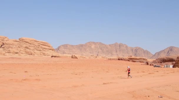 约旦瓦迪朗姆酒 2022年10月5日 旗帜和田径选手在极热的沙漠中快速行走 挑战超级十级的约旦多级超马拉松 — 图库视频影像