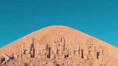Zoom in front view Statues wit heads on top of the Nemrut Mountain in Adiyaman, Turkey. Morning sunrise east side Nemrut Dagi