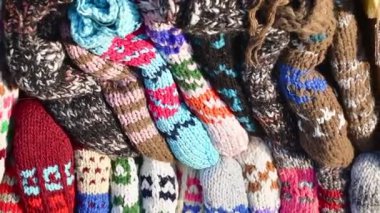 Close up traditional beautiful colorful hand-made socks for sale on display outside on babushkas stall