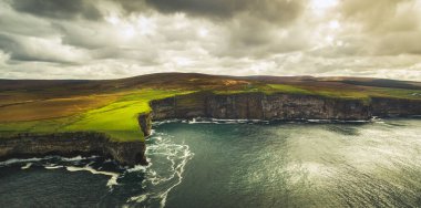 Ireland dramatic shoreline landscape. Waves crashing to rocky sea shore. Dramatic wild Ireland beautiful coast along wild atlantic way