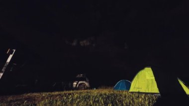 Vashlovani, Georgia - 27 thmay, 2022: two tents by 4wd vehicle in camping area by rangers station in southern Georgia. Travel explore adventure tour with friends