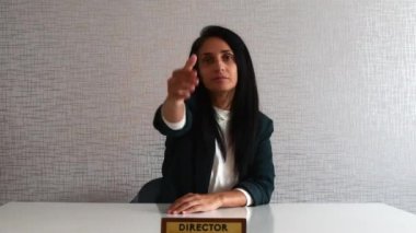 Young caucasian brunette business woman director in office behind desk give show hand for handshake from clients staff point of view perspective in office. Deal closed concept