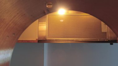 Female hands hold cup pour Water to silver cooking pot for food preparation in kitchen at home