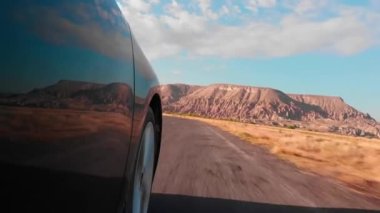 Point of view driving in cappadocia asphalt road outdoors with fairy chimneys background .Travel and tourism in Turkey concept