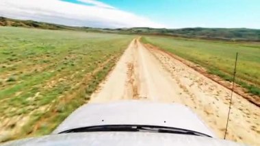 First person view front side 4WD vehicle drives real time on gravel road off-road in Chachuna nature reserve wilderness. 4k quality video exploration off-road tours outdoors in caucasus