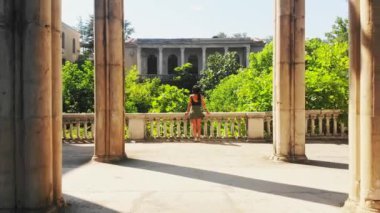 Point of view exploring old historical landmark site surrounded by columns background