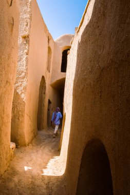 Woman tourist explore sightseeing alleys and corridors in traditional and historic village in Iran