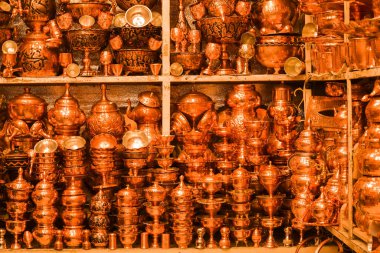 Shiraz, Iran - 15th june, 2022: Bronze pots in traditional muslim bazaar for sale. Handmade high-quality production