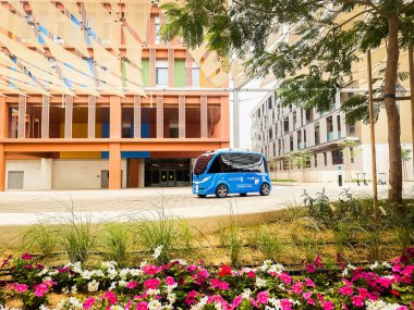 UAE, Abu Dhabi - 13th march, 2023: Autonomous car stand in futuristic city Masdar by Eco-friendly architecture. Masdar future City concept in UAE clipart