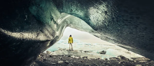 stock image Panoramic view of tourist by Fjallsjkull glacier in Iceland from inside glacier cave. Explore sightseeing Iceland hidden gems. Famous travel destination south Iceland.