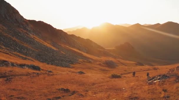 在秋天美丽的落日下 男女远足者一起在户外小径上远足 在高加索高山的远足中 对着阳光活动的人的慢动作 — 图库视频影像
