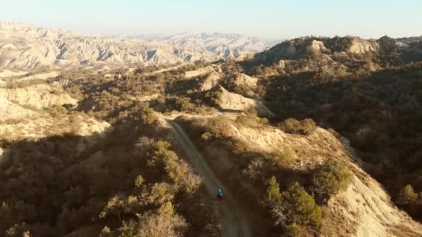 Aerial Overhead View Male Cyclist Cycling Deserted Badlands African Alike — Stock Video