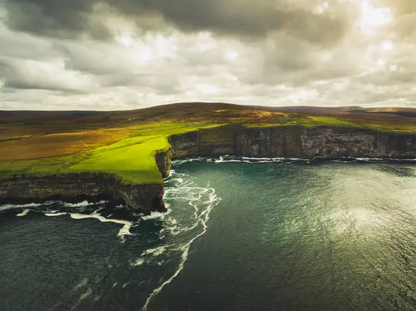 Ireland dramatic shoreline landscape. Waves crashing to rocky sea shore. Dramatic wild Ireland beautiful coast along wild atlantic way