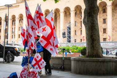 Tiflis, Gürcistan - 16 Mayıs 2024: yayalar parlamento önünde AB ve Gürcistan bayraklarını geçti