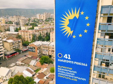 Tbilisi, Georgia - 9th august, 2024- Aerial view giant dreamers party political agitation billboards on city buildings in Giorgi Saakadze square. Georgian Dream ruling political party in Georgia. clipart