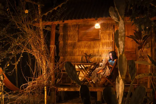 stock image Young caucasian hipster woman sit use computer at night work late freelancing work, write travel blog or browse internet search, work online while traveling in southeast asia tropical islands