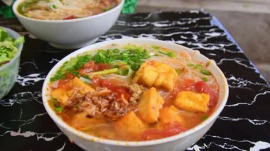 Pho - Vietnam çorbası çorbası çorbası çorbası çorbası, pirinç eriştesi, şifalı otlar ve yerel bir restorandaki masada et. Pho - Sokaklarda ve evlerde servis edilen Vietnam 'da popüler yiyecekler