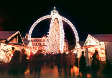 Vilnius, Litvanya - 30 Kasım 2024: hareket bulanıklığı çeken insanlar Xmas pazarından alışveriş yapıyor ve VVilnius şehrindeki güzel Xmas ağacını görüyorlar - 2025 Noel 'inin Avrupa başkenti