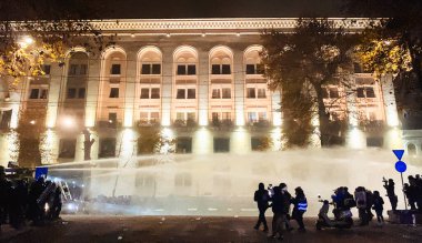 Tbilisi, Georgia - 1st december, 2024:Police special forces walk in street chase Protesters protesting stand for EU in Rustaveli avenue. European Union manifestation. Protests against Government clipart