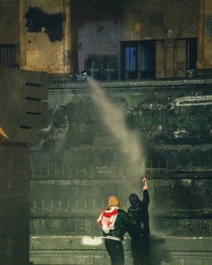 Tbilisi, Georgia - 1st december, 2024:young protesters georgians by parliament protest and stand for EU. European Union manifestation. Protests against Government.Security spray water on demonstrators clipart