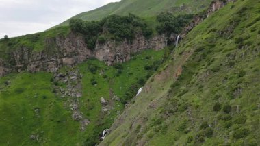 Yeşil kafkas dağlarında Arsha şelalesi havadan görünüyor. KAzbegi Ulusal Parkı. Görecek ve yapacak şeyler. Popüler gezi gezisi eğlencesi. Gürcistan seyahat hedefi kavramı