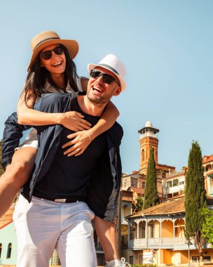 Romantik Çiftler tatilde Tiflis sokaklarında gezerken eğleniyorlar. Mutlu arkadaşlar tatilde birlikte gülerler - insanlar ve tatil kavramı. Kadını taşıyan adam birlikte zaman geçirmekten hoşlanır.