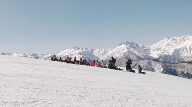 Svaneti, Gürcistan - 2025: Panning view Snowboard eğitmeni, kış kayak sezonu boyunca Gürcistan 'ın dağlık yamacında kar kayağı yapan snowboardculara ders veriyor.