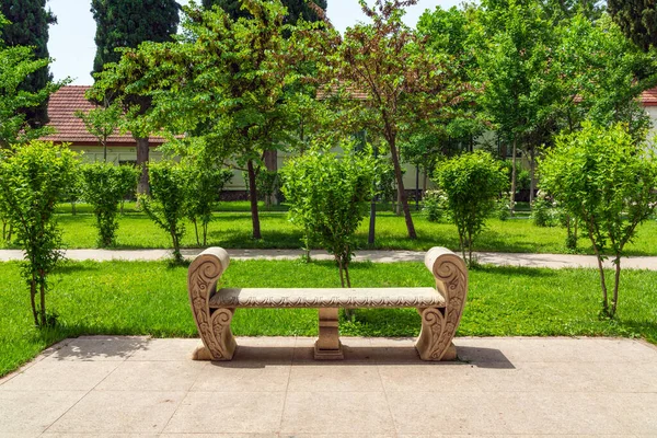 Empty stone bench in city park